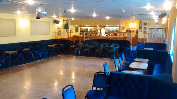 Function hall with dance floor and full length bar.